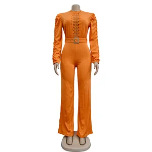 Chic orange long-sleeved jumpsuit featuring lace hollow design and a matching waist belt