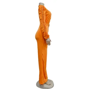 Detailed side view of vibrant orange long sleeve jumpsuit featuring lace hollow-out sleeves