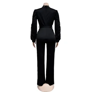 Back view of an elegant black long sleeve jumpsuit featuring lace hollow-out details