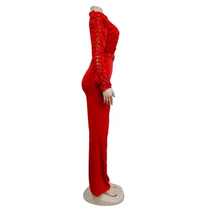 Side view of red long sleeve jumpsuit with lace hollow sleeves and belt