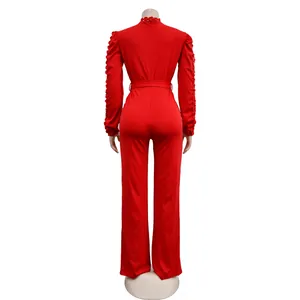 Back view of elegant red long sleeve jumpsuit with lace hollow-out details and belt