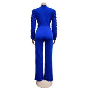 Back view of royal blue long sleeve jumpsuit with elegant lace detailing and belt.