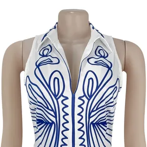 Close-up detail view of an elegant white sleeveless top with blue abstract linear print