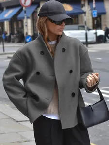 Detail view of a grey double-breasted woolen coat in a chic casual British street style