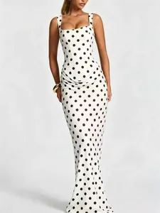 Slim fit white polka dot maxi dress with square neckline and elegant draping detail.