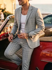 Close-up of grey plaid suit set for men in a casual business setting with a classic car