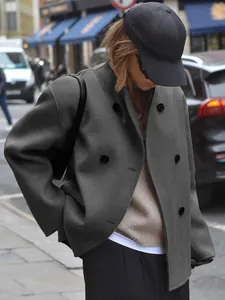 Close-up of a stylish gray double-breasted wool jacket showing premium texture and fit