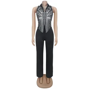 Front view of elegant black two-piece set with white printed halter top and trousers