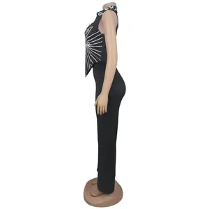 Side view of a black two-piece set with a white printed top and long pants.