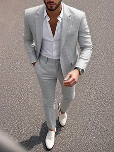 Detail view of light grey plaid business suit for men with tailored blazer and trousers.