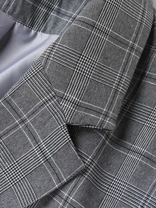 Detailed close-up of grey plaid blazer collar showing premium fabric texture and fine stitching