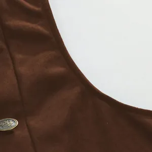 Close-up of brown suede men's business waistcoat showing decorative metallic button detail