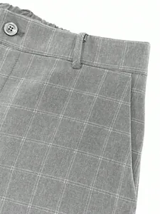 Macro detail of gray plaid pattern and waistband on business casual suit trousers