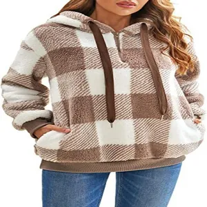 Detailed view of women's fuzzy brown and white checkered hoodie with drawstring and zip