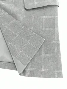 Close-up of grey plaid fabric texture on a professional men's blazer jacket