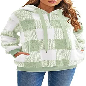 Close-up detail of women's cozy green plaid plush hooded sweatshirt with half-zip