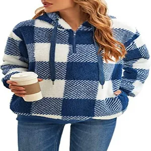 Detail view of a cozy blue and white buffalo plaid fuzzy hoodie with half-zip hood