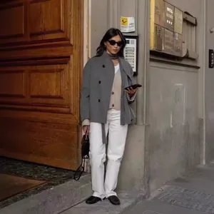 Women's double-breasted gray woolen coat in elegant British street style photography shot