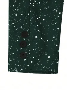 Close-up of men's dark green blazer cuff with metallic splatter pattern and three black buttons
