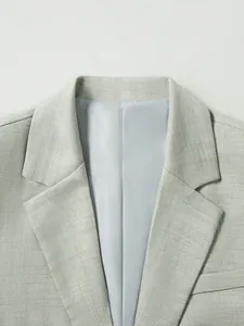 Détail du revers à cran d'une veste de costume homme texturée de couleur vert pâle