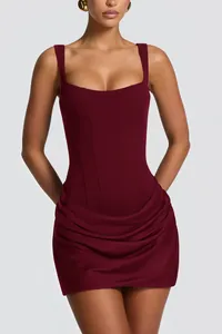 Close-up of wine red sleeveless corset mini dress showing draped skirt and bodice