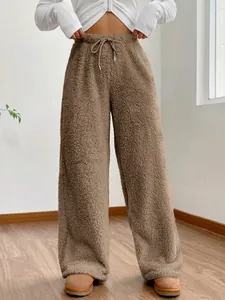 Close-up showing the soft fleece texture and high-waist drawstring of these brown pants.