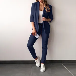 Detail view of navy blue two-piece leisure suit for women with slim fit blazer and pants.