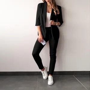 Detailed view of women's casual black business blazer set with slim-fit trousers and sneakers