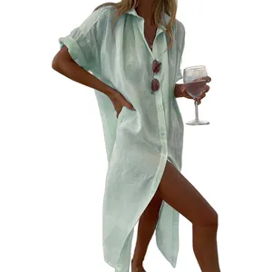 Elegant light green oversized cotton linen shirt dress used as a stylish summer beach cover-up