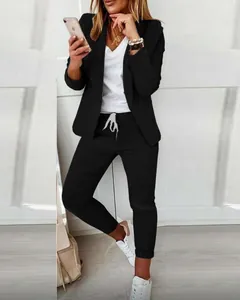 Detail shot of a woman's casual black two-piece suit set with a blazer and joggers.