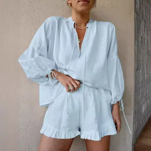 Stylish light blue linen two-piece set with lantern sleeve top and ruffled shorts