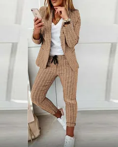 Detailed view of women's casual brown plaid blazer and matching trousers suit set