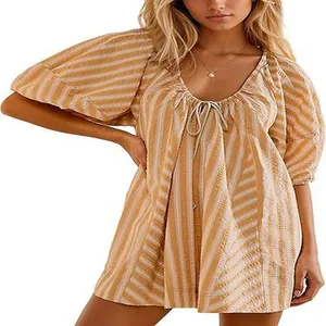 Close-up detail of the yellow striped summer playsuit featuring a deep V-neck and tie