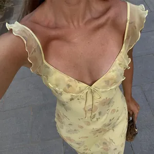 Detail view of a vintage floral print slip dress with a sexy low-cut V-neck and bow tie.