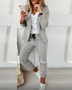 Detailed view of women's fashion plaid two-piece suit set with blazer and trousers