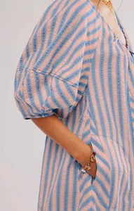 Close-up of pink and blue striped summer romper with textured fabric and side pockets