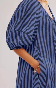 Close-up detail of blue and black striped short sleeve playsuit with loose sleeve texture