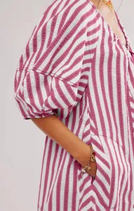 Close-up detail of purple striped summer jumpsuit featuring puff sleeves and functional pocket