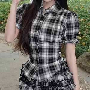 Close-up of vintage black and white plaid puff sleeve shirt with button-down detail