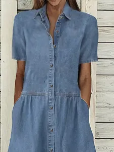 Detail view of a casual light blue denim shirt dress with lapels and button front