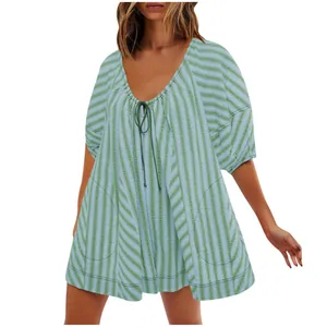 Detail view of women's summer striped short jumpsuit with deep V-neck and tie detail