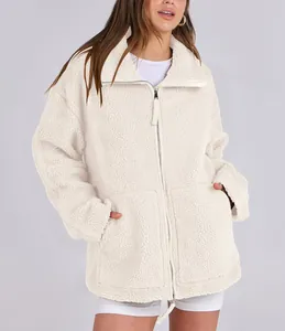 Detail of oversized cream plush sherpa jacket with double zipper and front pockets