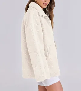 Side view of an oversized cream teddy jacket showing soft plush texture and zip detail.