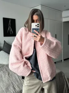 Close-up of pink textured fleece jacket with drop shoulders and metallic snap buttons