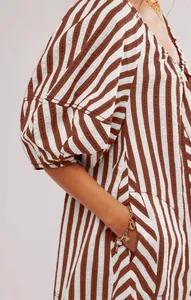 Close-up of stylish brown striped short sleeve romper with puff sleeves and side pockets