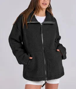 Close-up of an oversized black fuzzy teddy jacket featuring a double zipper design.