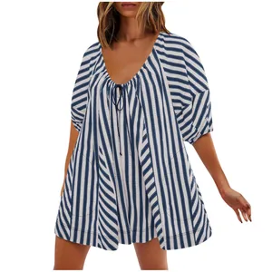 Front view of a loose-fitting blue and white striped romper with deep V-neck and tie detail