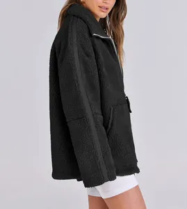 Detailed side view of a black oversized warm teddy fleece jacket with double zipper