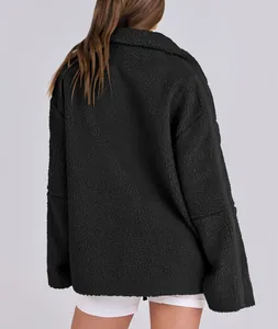 Detailed back view of a women's oversized black teddy fleece jacket with plush texture