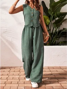 Full view of green linen-textured summer set styled with straw bag in a garden setting